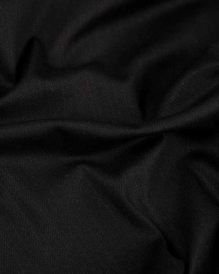 Close up view of stretch denim jeans for men by Luxire in black 2