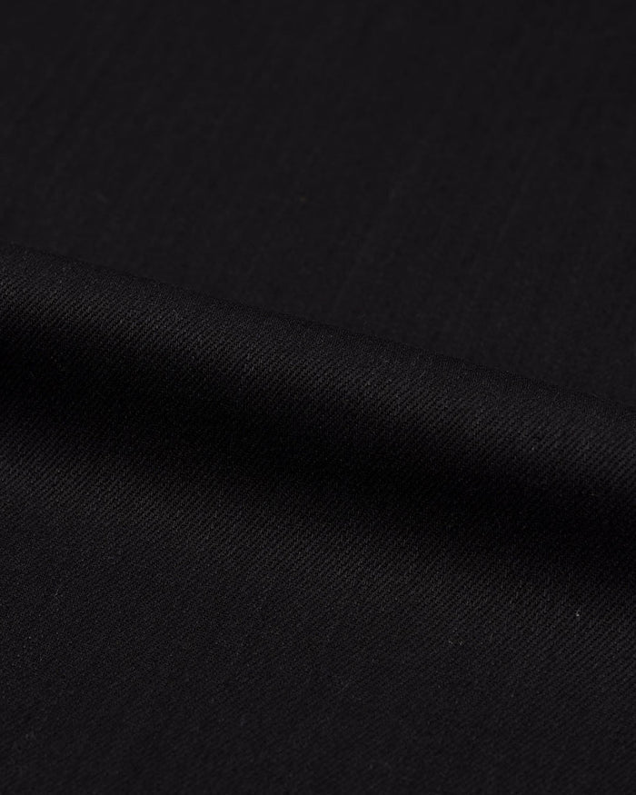 Close up view of stretch denim jeans for men by Luxire in black 3
