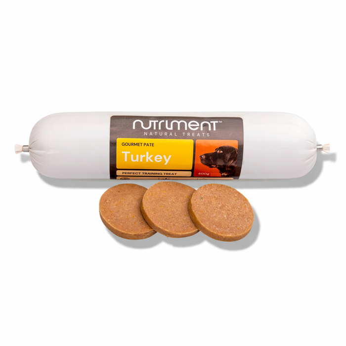 A tube of Gourmet Turkey Pate 400g dog treat with three round slices in front.