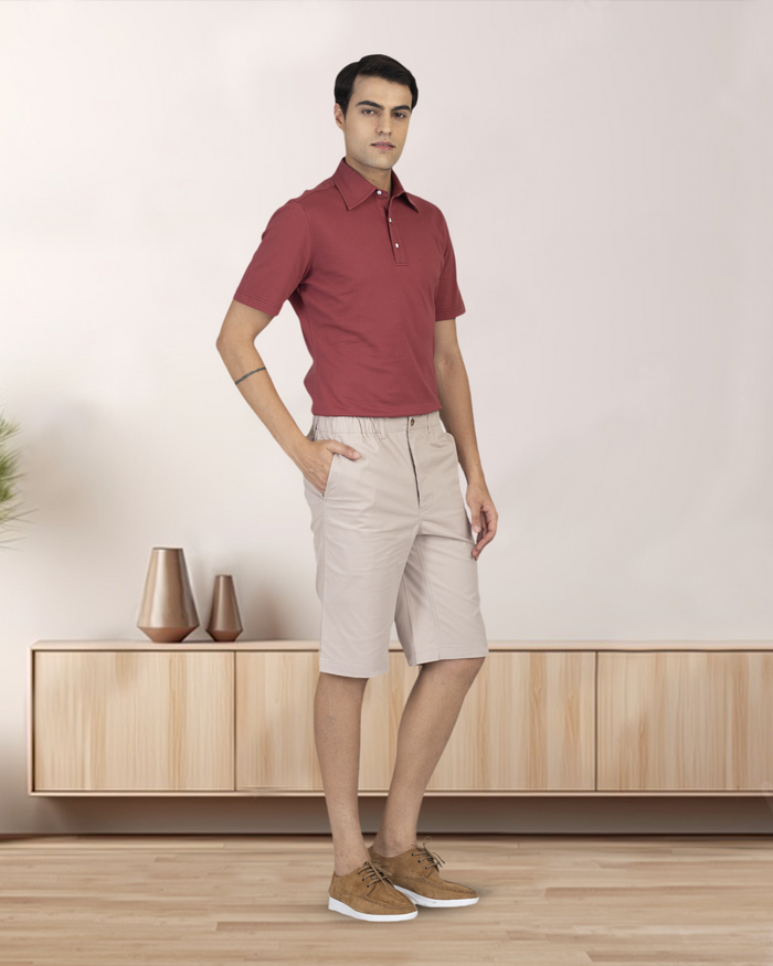 Front of model wearing the custom oxford polo shirt for men by Luxire in soft marsala