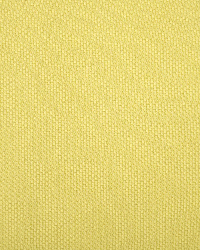 Close up of the custom oxford polo shirt for men by Luxire in mid yellow