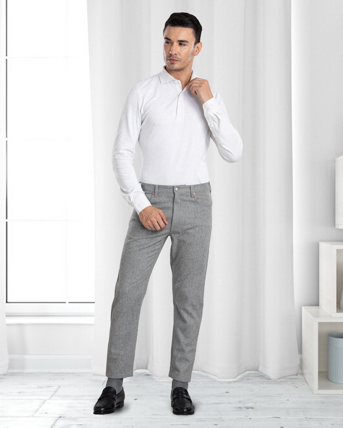 Model wearing the custom oxford polo shirt for men by Luxire in ivory white hand at shoulder