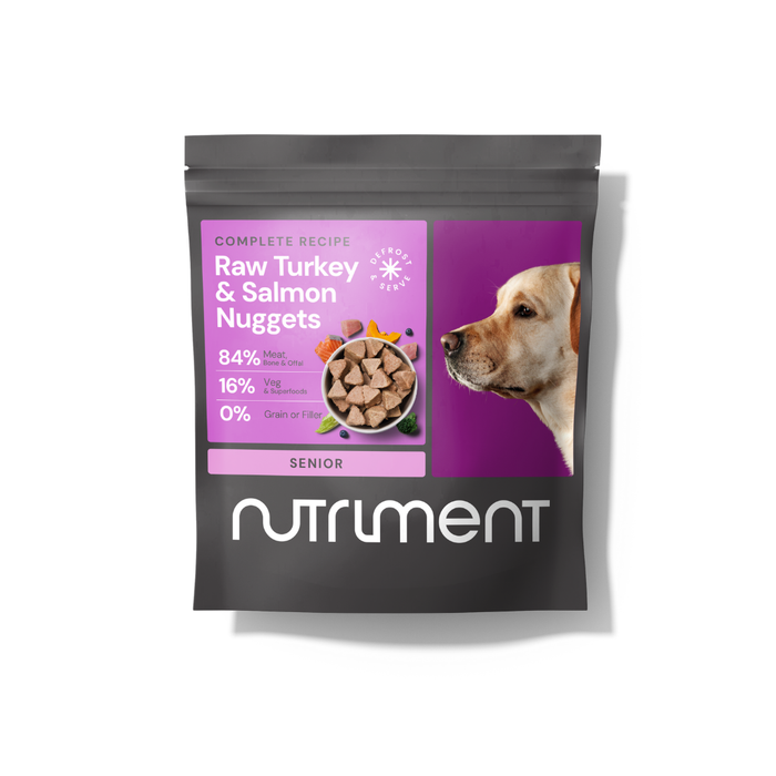 Black Nutriment bag labeled "Raw Beef Nuggets 1kg," grain-free pet food for senior dogs, with dog photo.